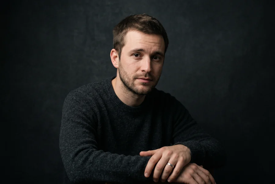 A man wearing the same plain hairstyle he has had for years, deciding whether to try on hairstyles that differ from it